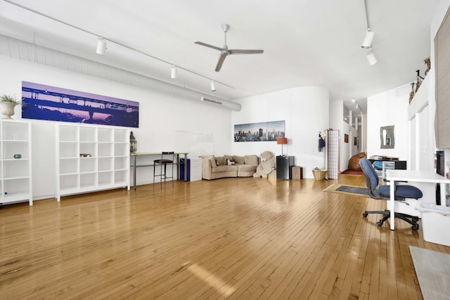 home office featuring track lighting, visible vents, hardwood / wood-style floors, and a ceiling fan