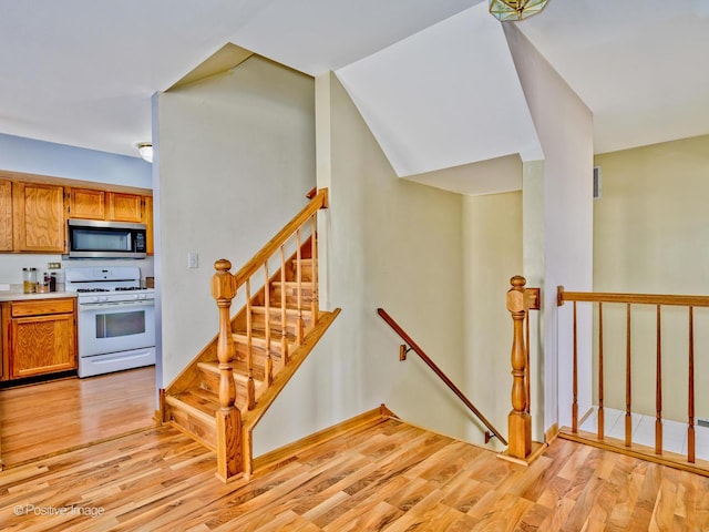 stairway featuring wood finished floors