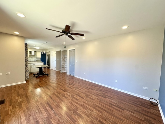 unfurnished living room with dark wood-style floors, ceiling fan, baseboards, and recessed lighting