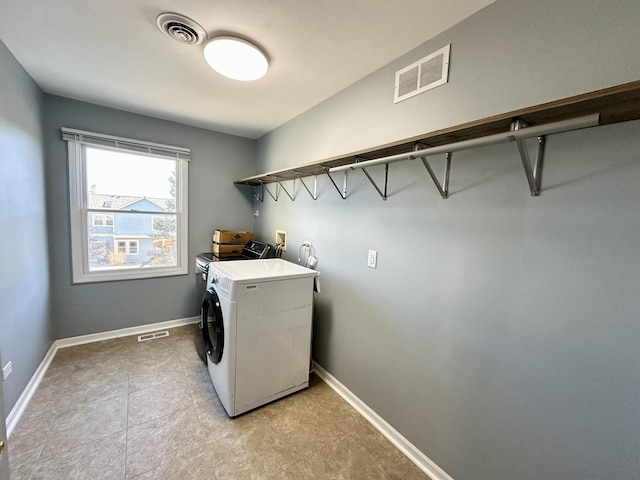 laundry room with laundry area, baseboards, and visible vents