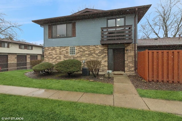 view of front of house featuring brick siding and fence