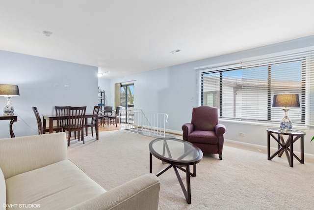 carpeted living area with visible vents and baseboards