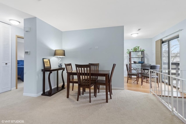 dining area featuring carpet floors and baseboards