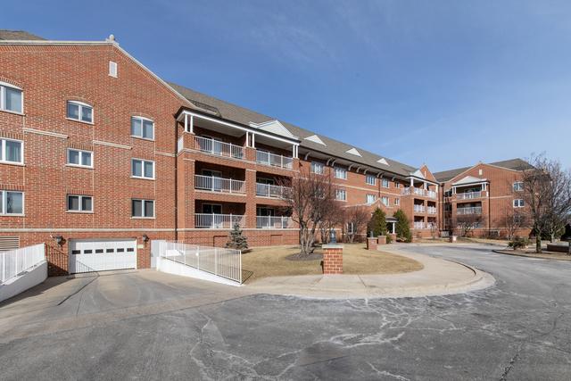 view of building exterior with a garage and fence