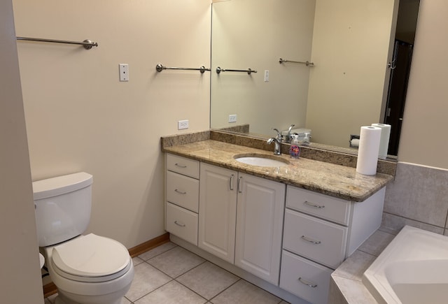 bathroom with a tub, vanity, toilet, and tile patterned floors