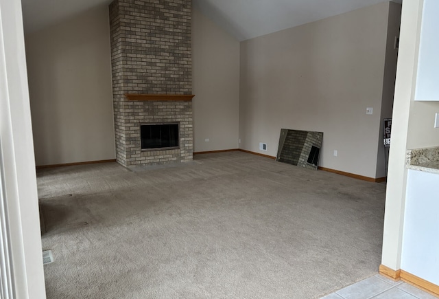 unfurnished living room featuring lofted ceiling, carpet floors, a brick fireplace, and baseboards