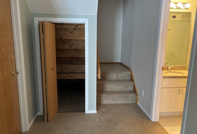 staircase with baseboards and carpet flooring