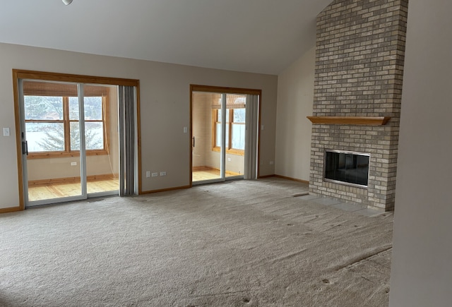 unfurnished living room with high vaulted ceiling, carpet, a fireplace, and baseboards