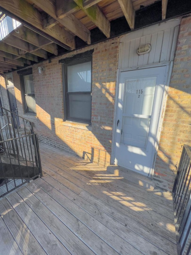 view of exterior entry with brick siding