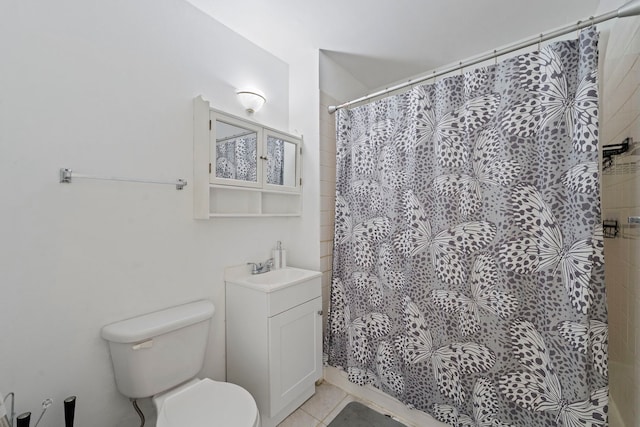 full bathroom featuring a shower with shower curtain, vanity, toilet, and tile patterned floors