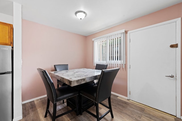 dining room with wood finished floors and baseboards