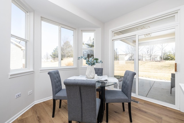 dining area featuring baseboards and wood finished floors