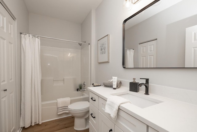 full bathroom featuring vanity, shower / bathtub combination with curtain, toilet, and wood finished floors