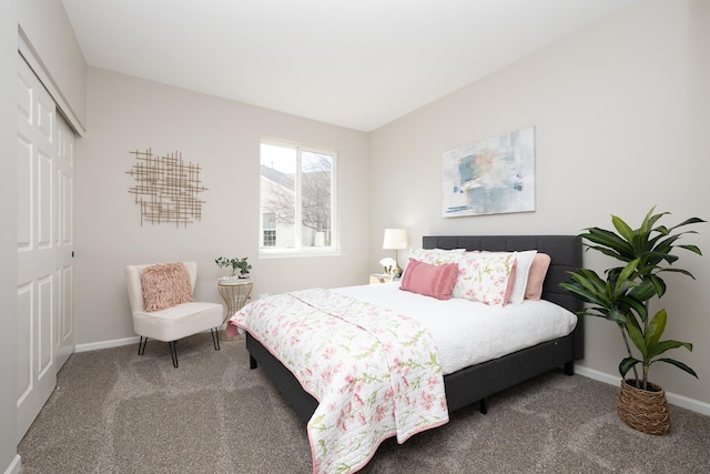 bedroom featuring a closet, baseboards, and carpet