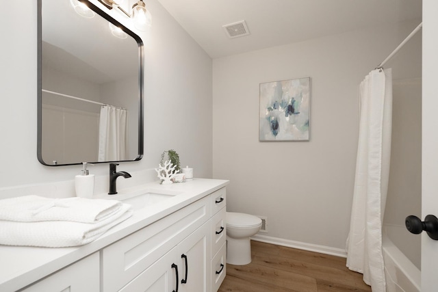 full bathroom featuring visible vents, toilet, wood finished floors, baseboards, and vanity