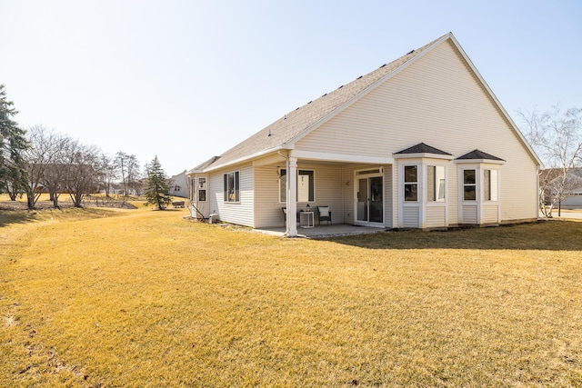 back of house featuring a patio area and a lawn