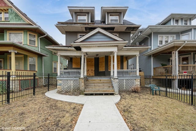 view of front facade with a porch and fence