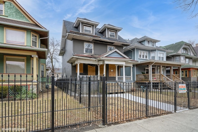 view of front of property with covered porch and a fenced front yard