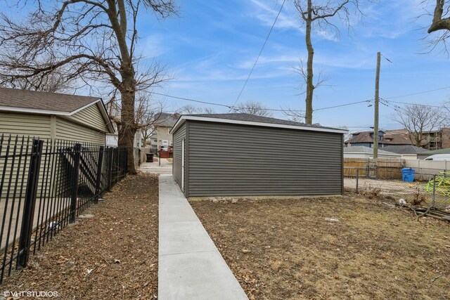 exterior space with a fenced backyard and an outdoor structure