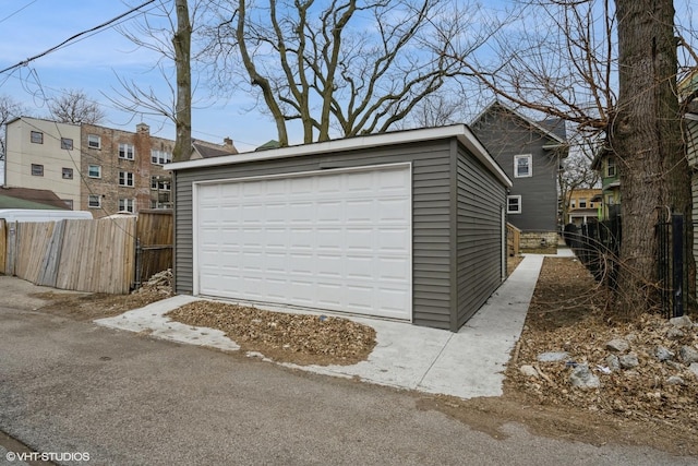 detached garage featuring fence