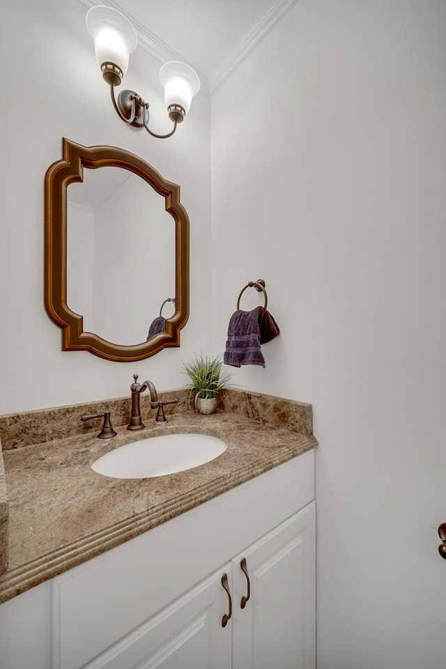 bathroom with ornamental molding and vanity