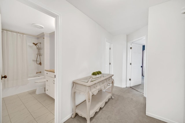 corridor with marble finish floor and baseboards