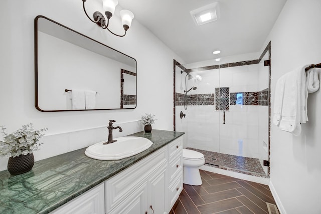 bathroom featuring visible vents, vanity, a shower stall, and toilet