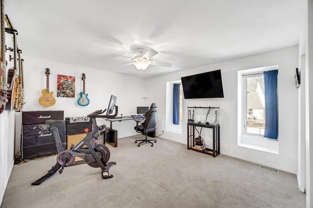 workout room featuring carpet floors, visible vents, and ceiling fan