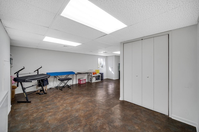 recreation room with a paneled ceiling