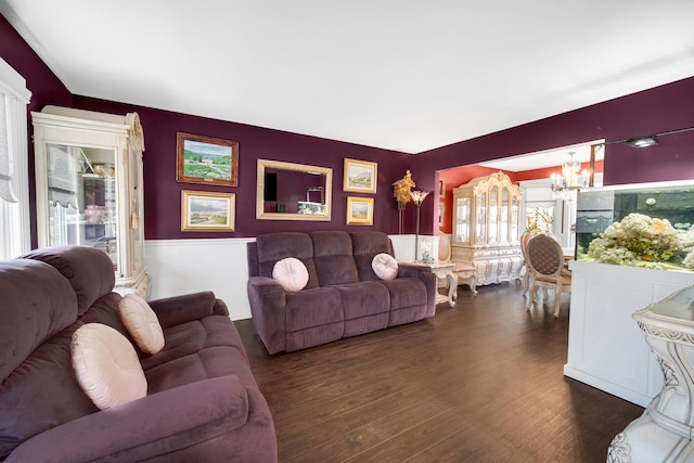 living room featuring dark wood-style floors and an inviting chandelier