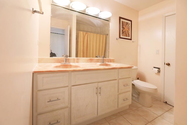 bathroom with a shower with shower curtain, vanity, toilet, and tile patterned floors