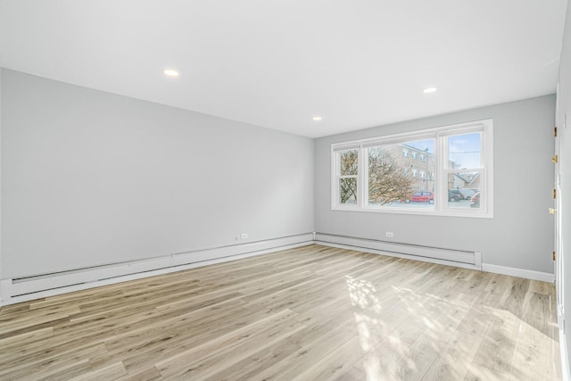 unfurnished room featuring light wood-type flooring, baseboards, baseboard heating, and recessed lighting