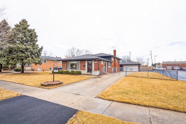 view of front facade with a front lawn, a chimney, fence, and brick siding