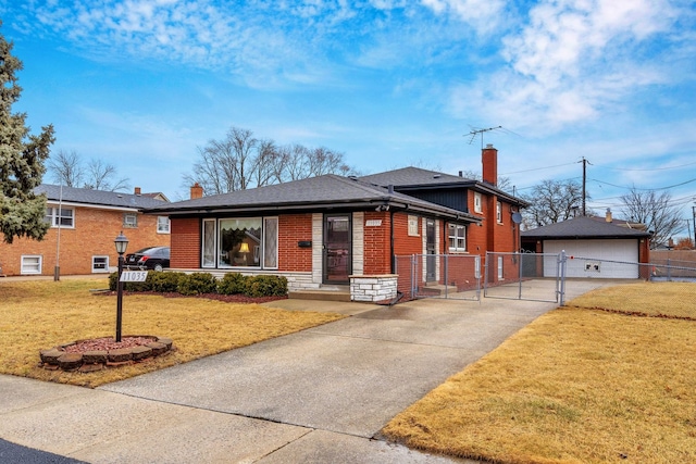 view of front facade with a chimney, a gate, fence, a front lawn, and brick siding