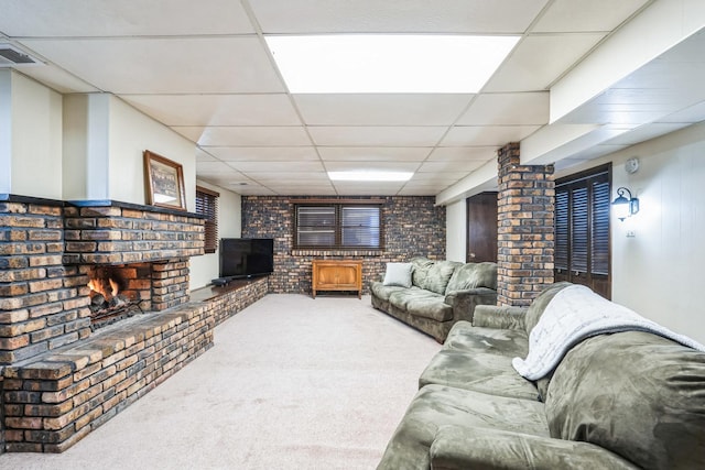 carpeted living room featuring a paneled ceiling, visible vents, and a fireplace