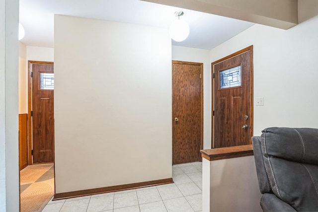 foyer entrance with light tile patterned floors