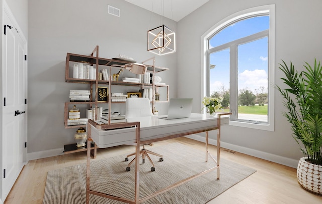 office area featuring wood finished floors, visible vents, and baseboards