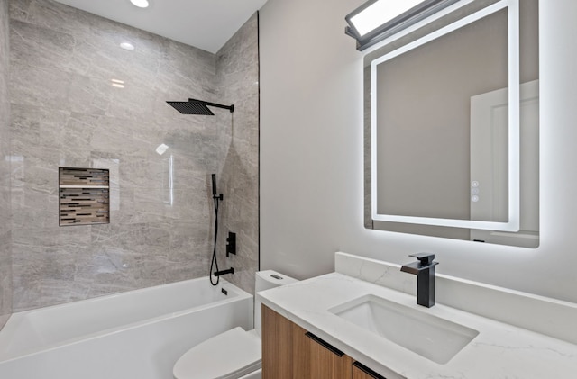 bathroom with tub / shower combination, vanity, and toilet