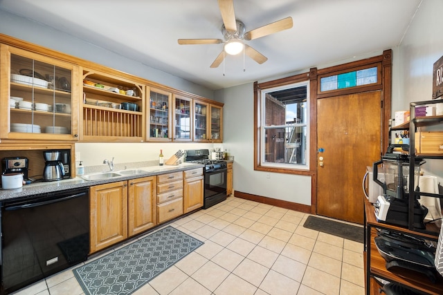 kitchen featuring light tile patterned floors, glass insert cabinets, a sink, black appliances, and baseboards