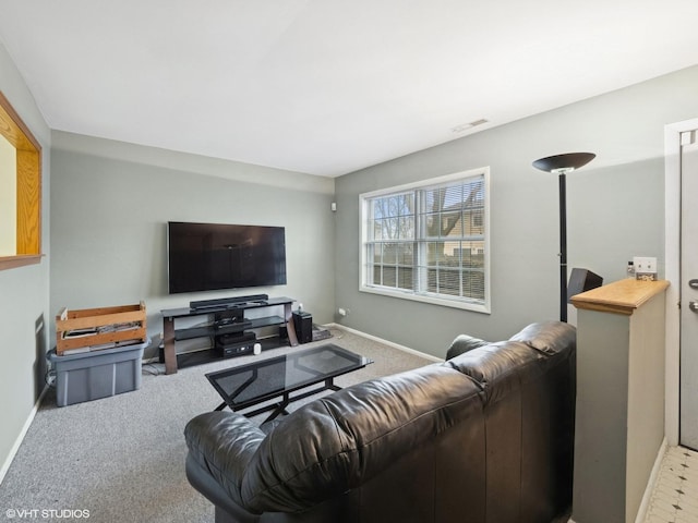 carpeted living room with visible vents and baseboards