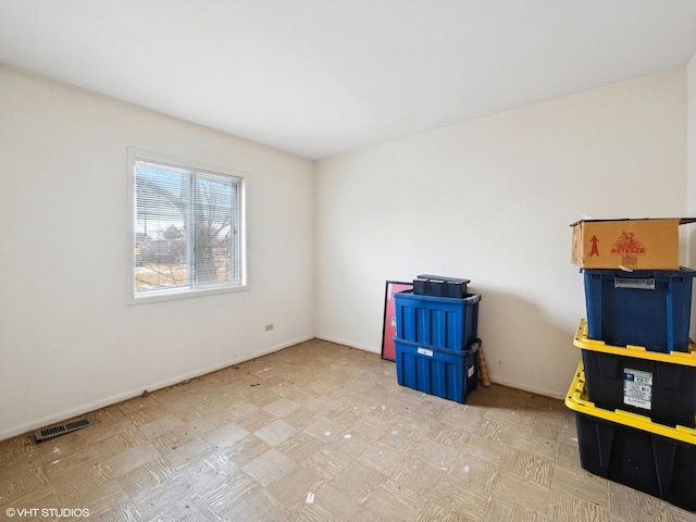 unfurnished room with baseboards, visible vents, and tile patterned floors