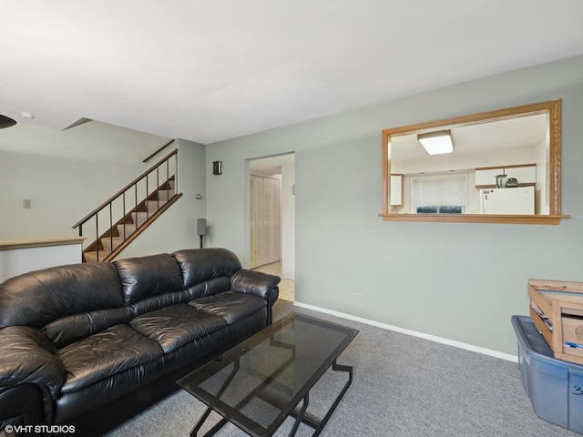 living room with carpet floors, baseboards, and stairs