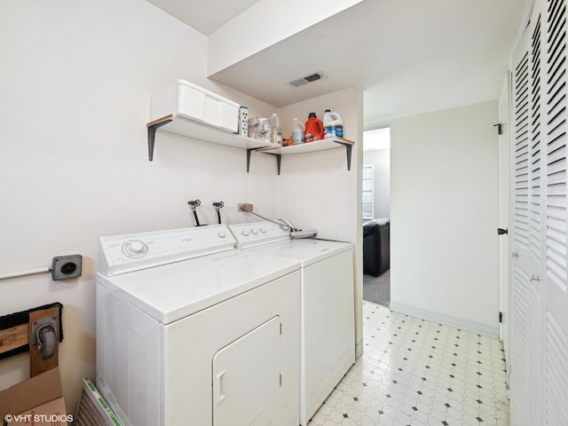 laundry room featuring laundry area, baseboards, visible vents, washer and clothes dryer, and light floors