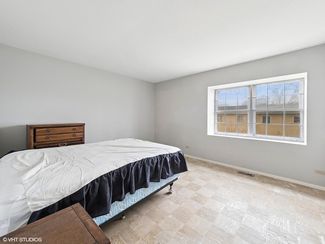 bedroom featuring visible vents and baseboards