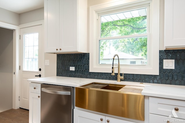 kitchen featuring a sink, backsplash, white cabinets, and dishwasher