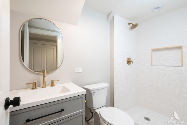 bathroom featuring a shower, vanity, and toilet