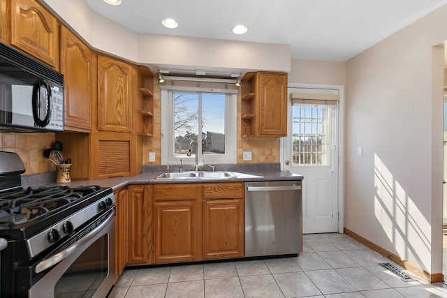 kitchen featuring brown cabinets, open shelves, stainless steel appliances, and a sink