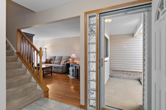 foyer entrance with light wood-style floors and stairs