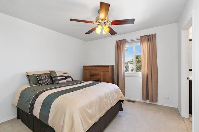 bedroom with light colored carpet, baseboards, and ceiling fan