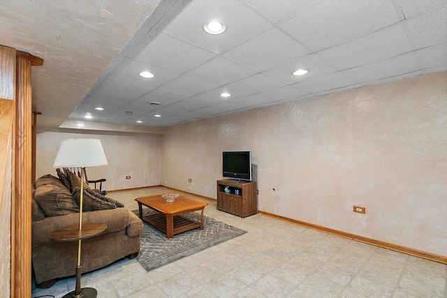 living area with tile patterned floors, a drop ceiling, recessed lighting, and baseboards